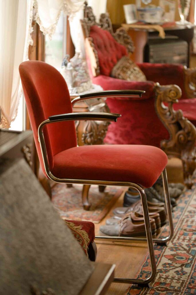 Gispen chair next to traditional chair and hearth